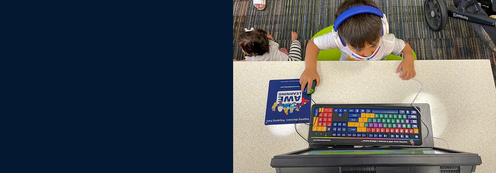 Young student using assistive learning technology and an adaptive keyboard