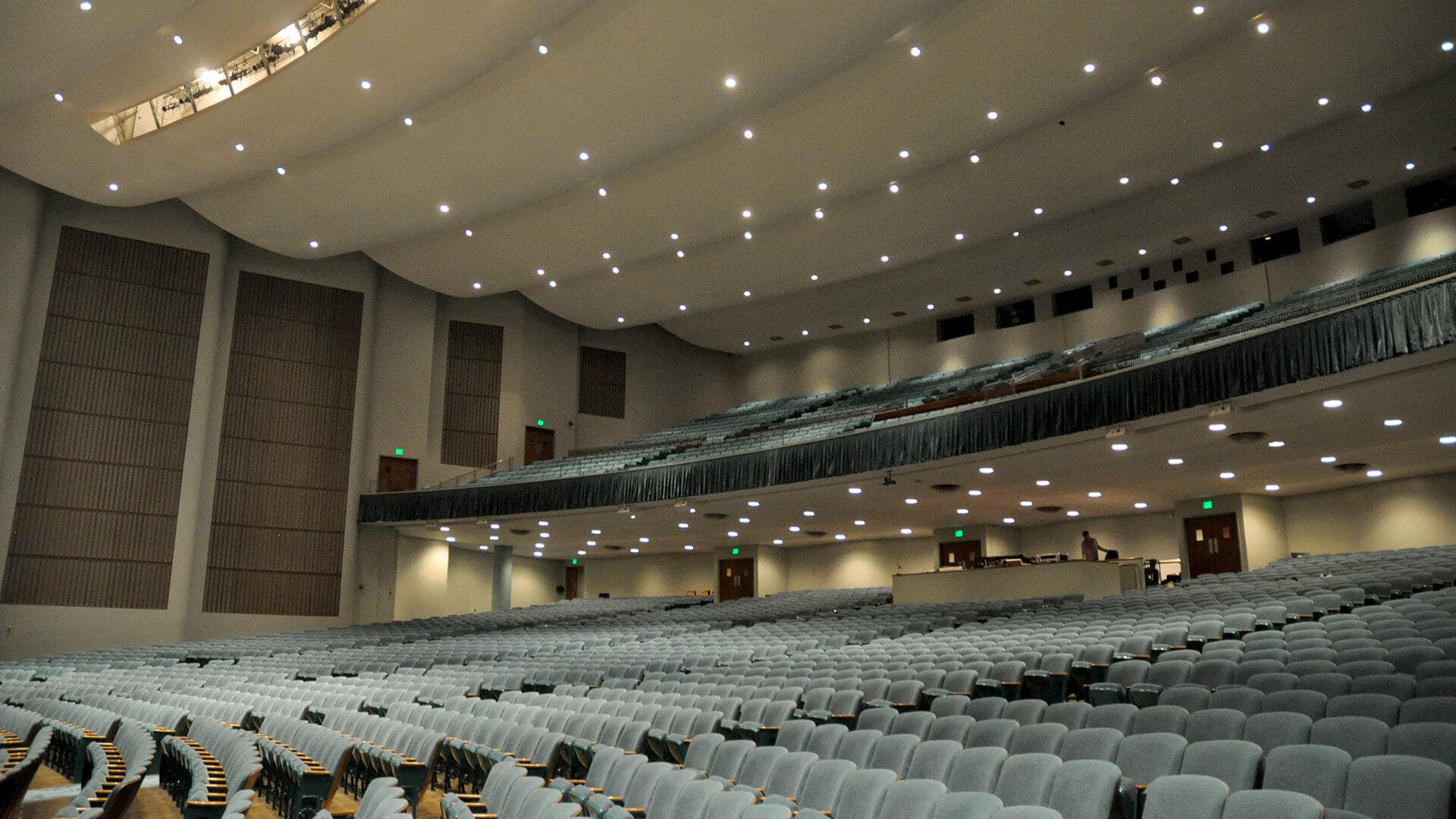 Large empty auditorium with rows of seats and a balcony